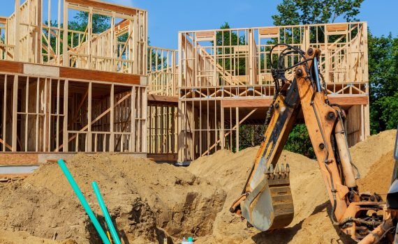 Unfinished house of still under construction. Building concept Unfinished house of still under construction. Building concept The excavator digs new building